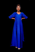 Front view of a blue asymmetrical gown with pintuck basket weave sleeve.