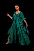 Green asymmetrical gown with pintuck basket weave sleeve.