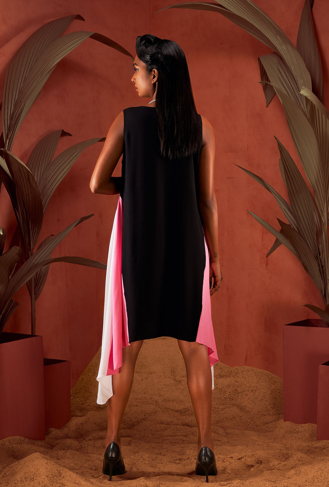 Front view of a black asymmetric sleeveless dress.