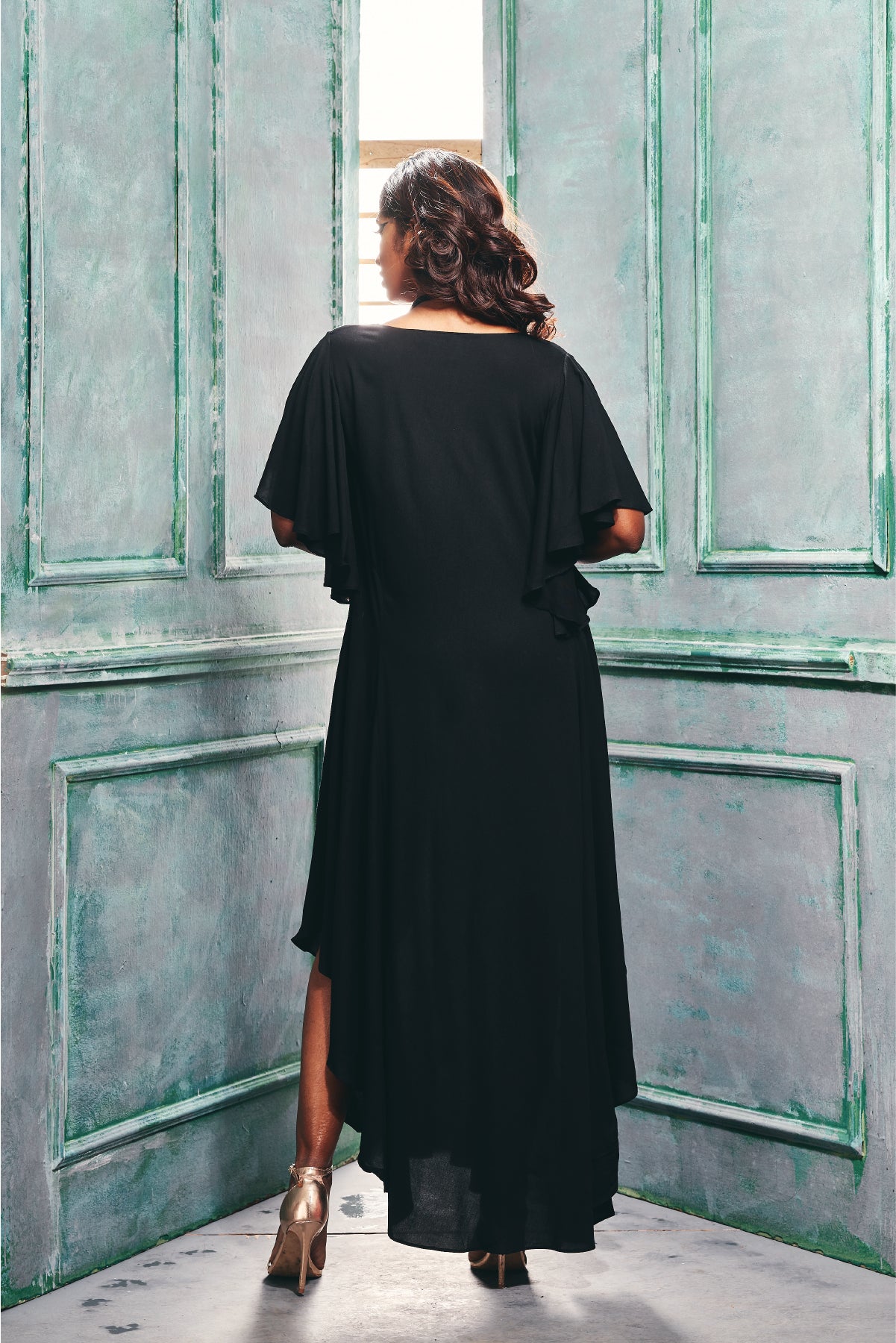 Back view of the dress With Asymmetrical Hemline & Cascade Sleeve.