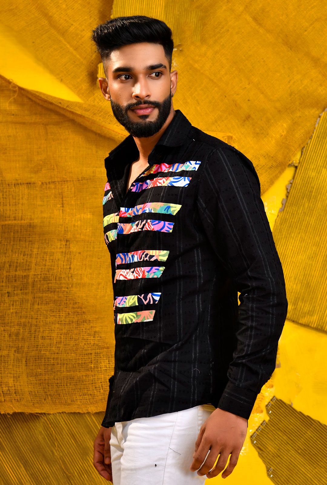 Front view of a black shirt with stripe patchwork.