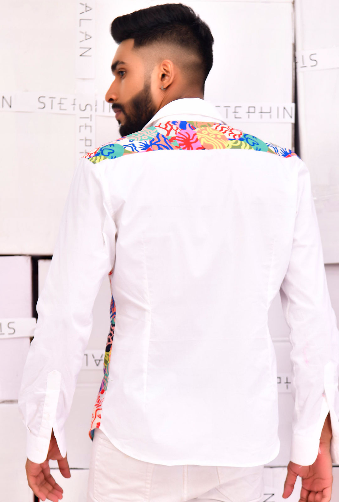 Front view of a white shirt with printed detailing.