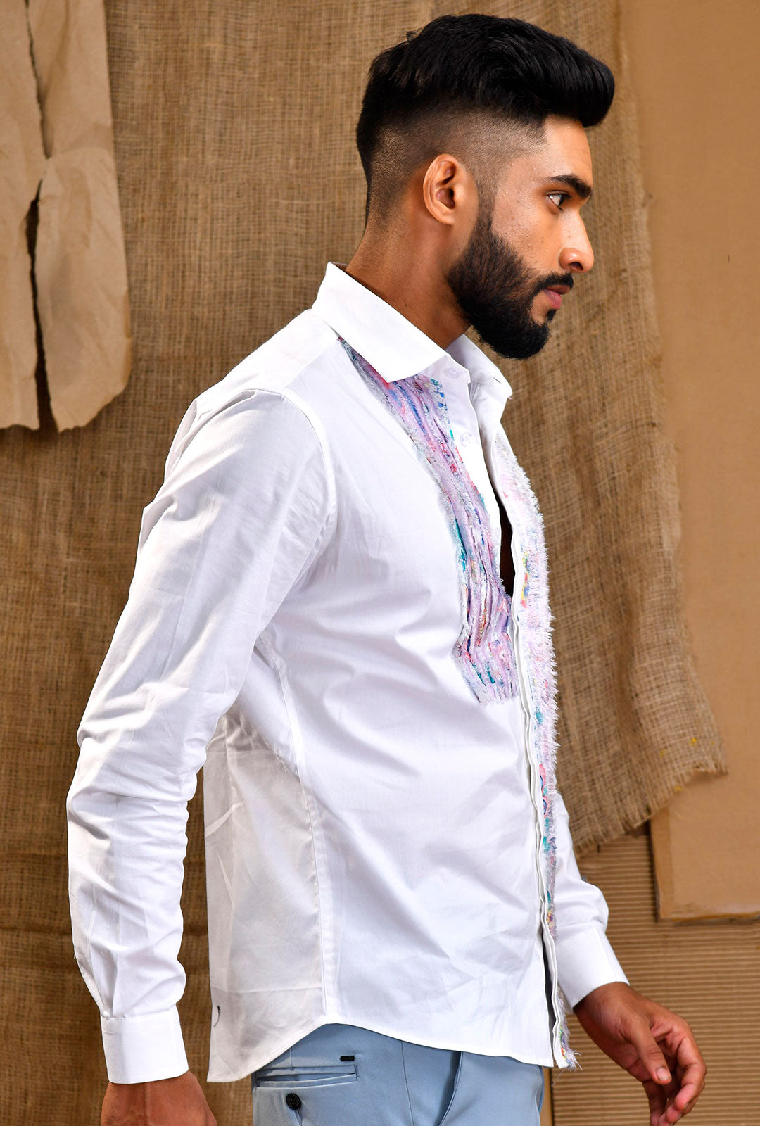 Front view of a white shirt with asymmetrical fray panel.