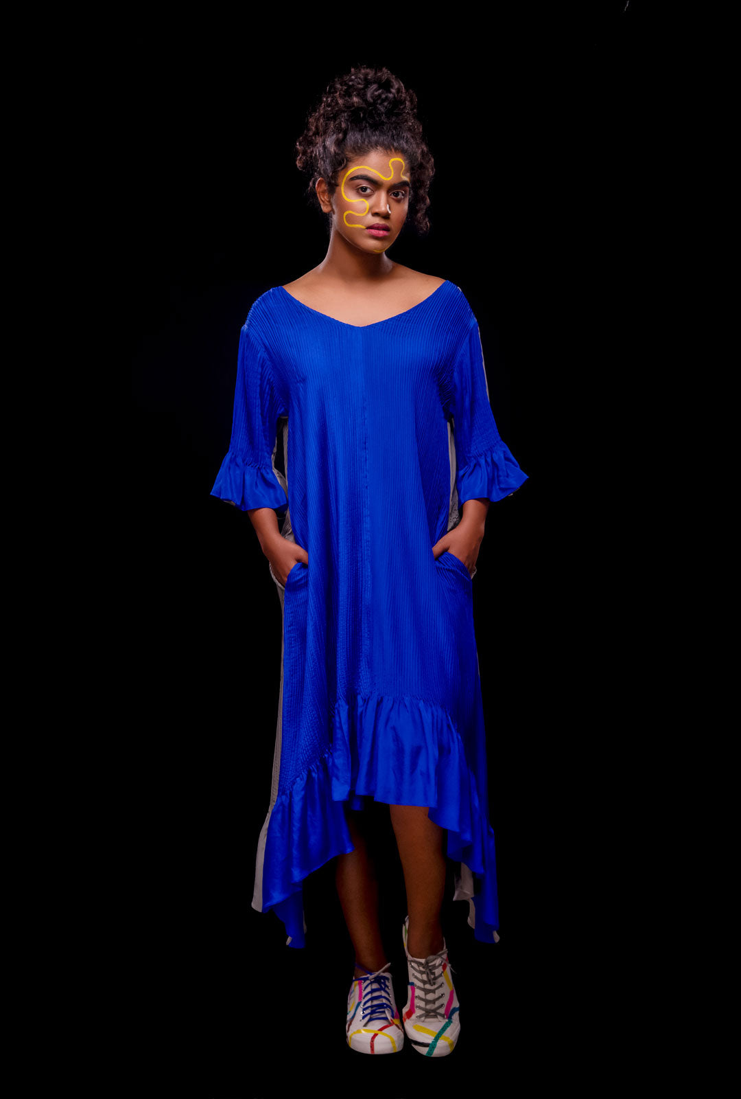 A model wearing a blue color reversible asymmetric dress.