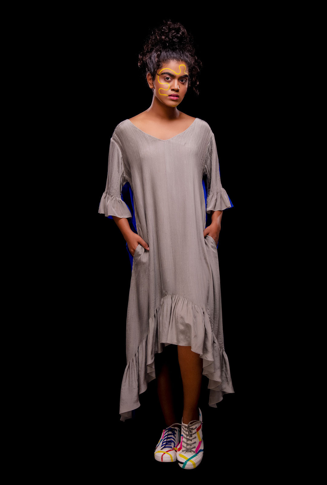 A model wearing a blue color reversible asymmetric dress.