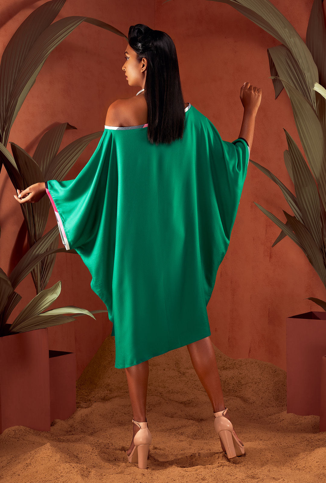 Side view of a green color solid tunic.