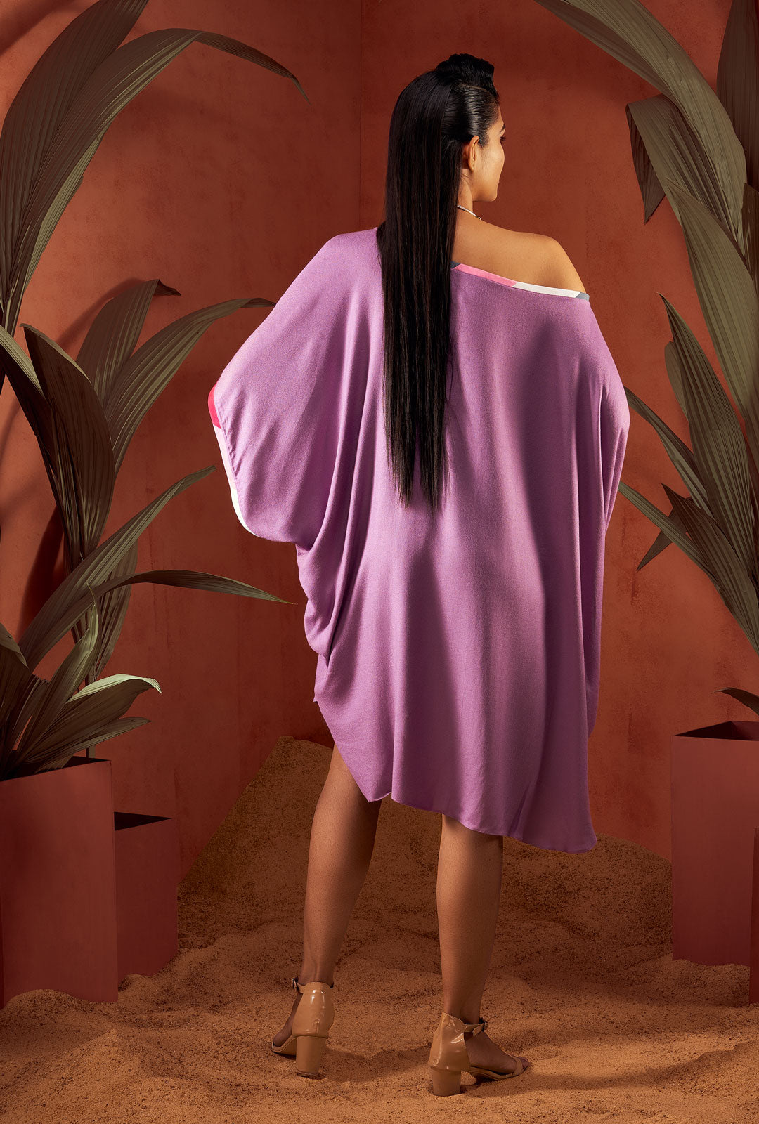 Side view of a green color solid tunic.