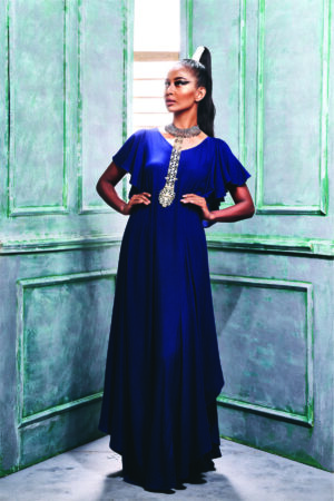 Front view of the midnight blue dress with hemline cascade sleeve.