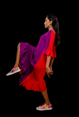 Side view of a reversible asymmetric dress showing dual colors.